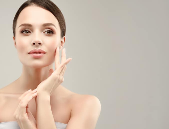 Gorgeous, young, blonde haired woman with clean fresh skin is looking straight on camera by magnetic look
