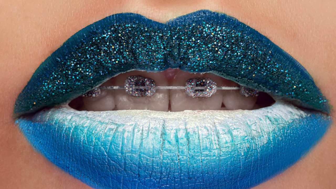Blue lipstick. Studio close up of a woman wearing blue lipstick posing seductively with her mouth open sexuality unusual creative artistic makeup lip gloss cosmetics art creativity sexy face concept